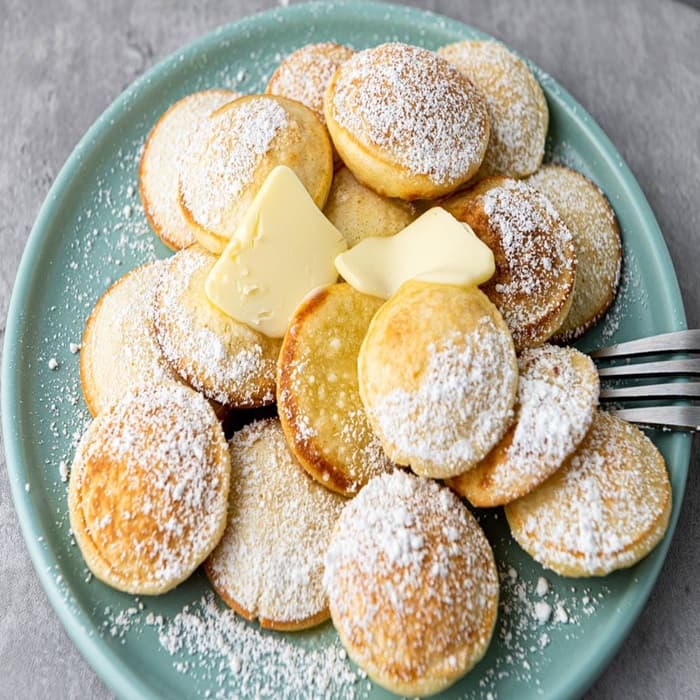 Source photograph of Dutch poffertjes (mini pancakes). Not official I Want Some Food pixel artwork.