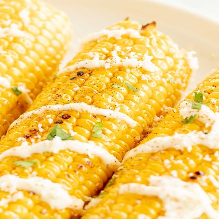 Source photograph of Grilled corn with garlic mayo & grated cheese